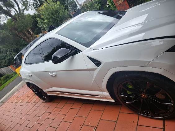 White Lamborghini Urus side view after completed panel repair