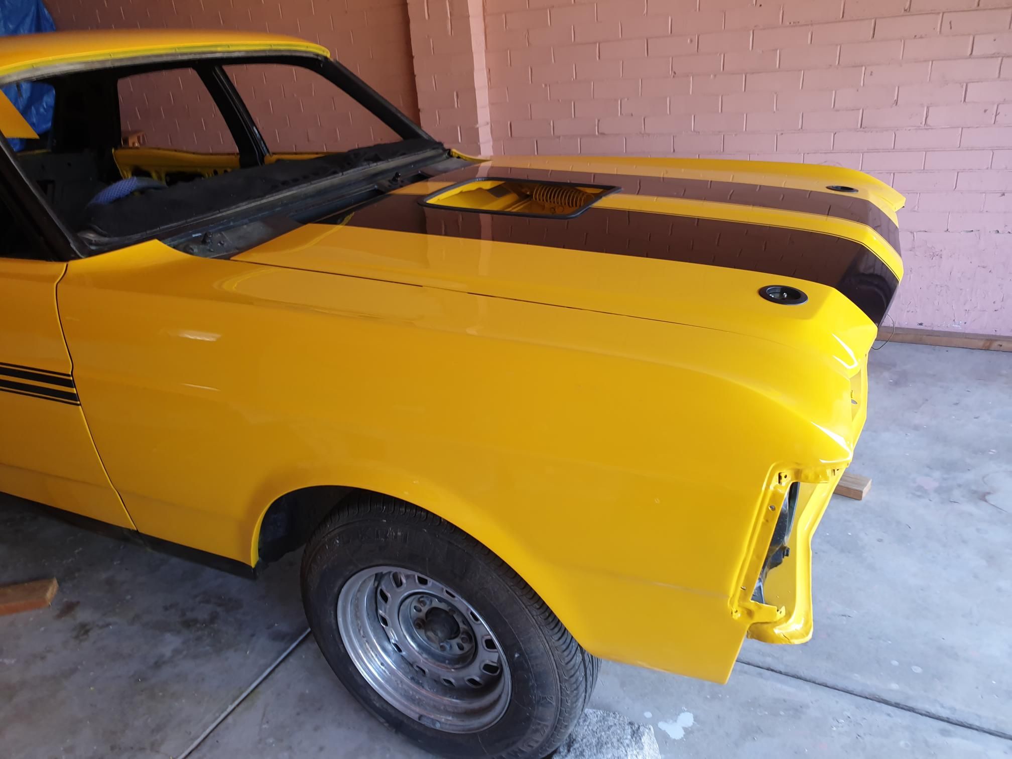 Classic car fully resprayed in vibrant yellow by Lucio